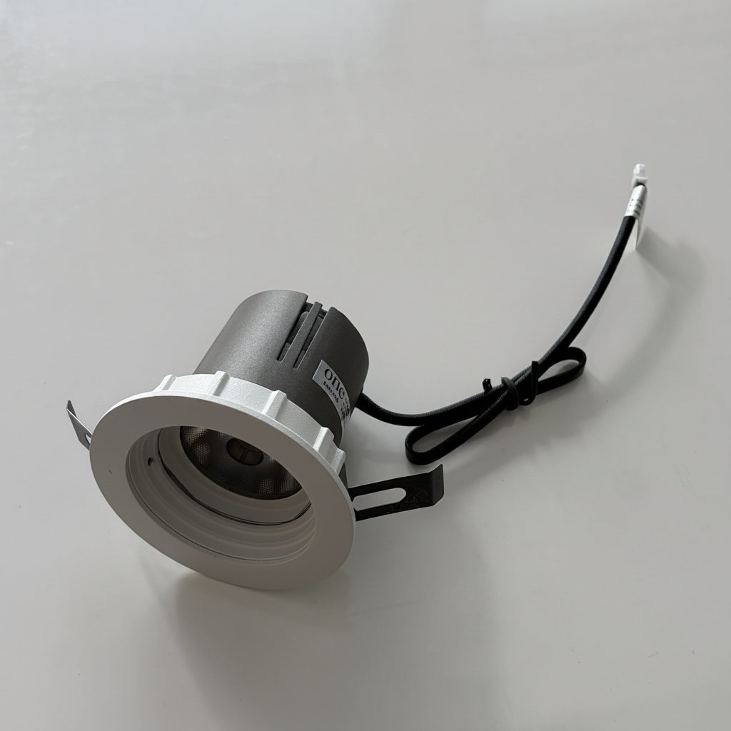 Small round light fixture on a white background