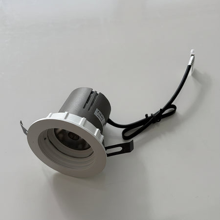 Small round light fixture on a white background